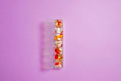 ZMA supplement capsules on a table alongside gym training equipment
