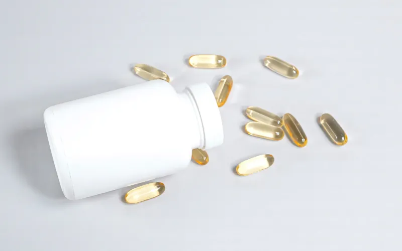 Supplement capsules spilling from a bottle - amino acid supplement